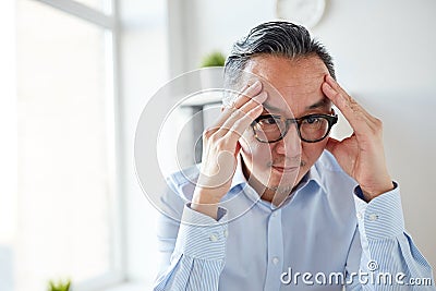 Anxious businessman in eyeglasses at office Stock Photo