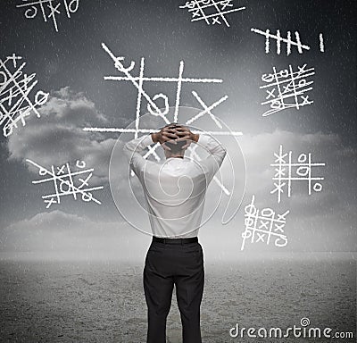 Anxious businessman losing at noughts and crosses Stock Photo