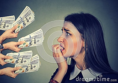 Anxious woman looking at money dollars offered by suspicious people Stock Photo