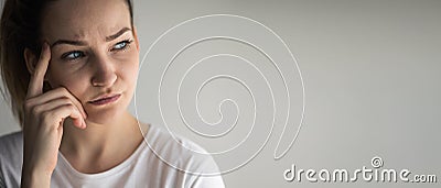 Anxious, worried, stressed young woman looking pensive Stock Photo