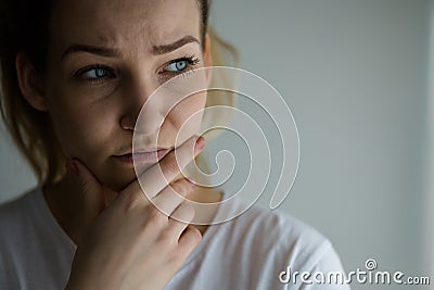 Anxious, worried, stressed young woman looking pensive Stock Photo