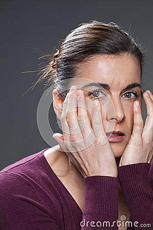 Anxious young brunette woman looking sad Stock Photo