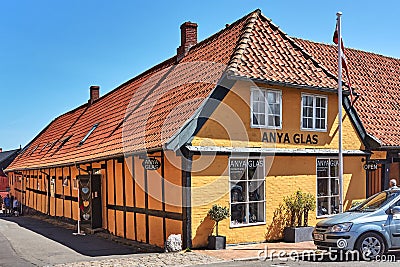 Anya Glass shop located in traditional building in Svaneke. Editorial Stock Photo