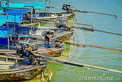 AO NANG, THAILAND - FEBRUARY 19, 2018: Above view of long tail fishing boats in a row at the riverside in the pier at Editorial Stock Photo