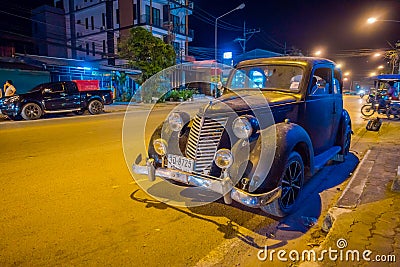 AO NANG, THAILAND - FEBRUARY 09, 2018: Outdoor view of old clasic black car parked in the streets during night in AO Editorial Stock Photo