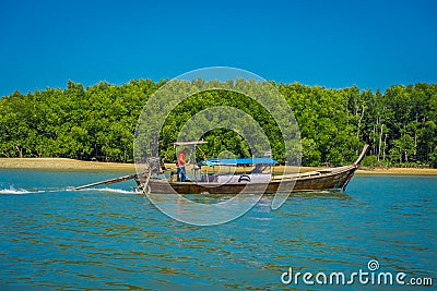 AO NANG, THAILAND - MARCH 05, 2018: Outdoor view of unidentified people traveling in Fishing thai boats in the river at Editorial Stock Photo