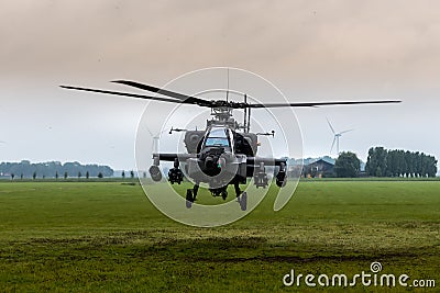 An Apache helicopter flies away from Flevoland Stock Photo