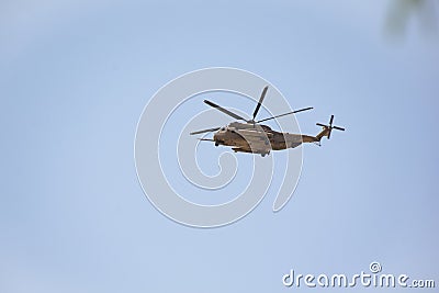 Apache Helicopter Flying over the Desert Stock Photo