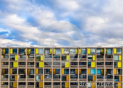 Apartment block facade with balconies and colourful windows Stock Photo