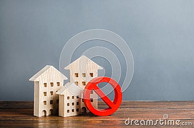 Apartment buildings and red prohibition symbol NO. Unavailable and expensive housing. Lack of living space and the impossibility Stock Photo