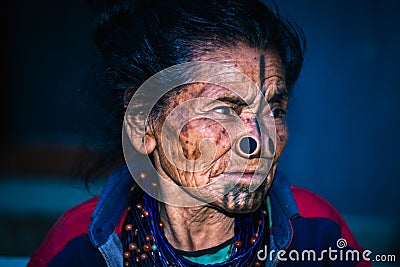 Apatani tribal women facial expression with her traditional nose lobes and blurred background Stock Photo