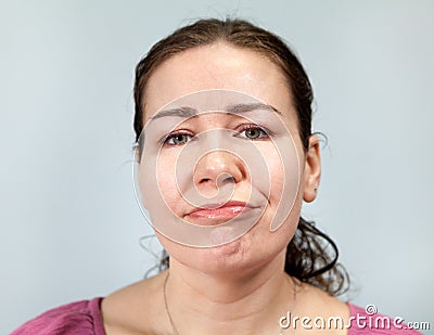 Apathy and laziness on the face of an adult woman, portrait on grey background, emotions series Stock Photo