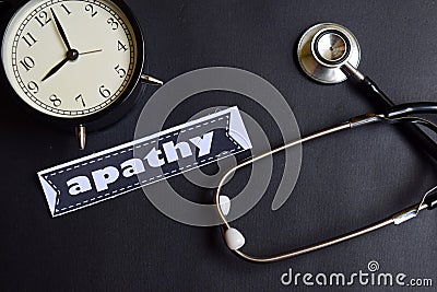 Apathy on the paper with Healthcare Concept Inspiration. alarm clock, Black stethoscope. Stock Photo