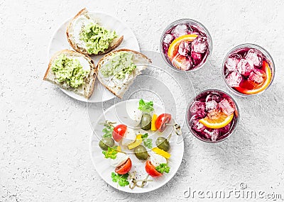 Aperitiv table - select and snack, top view. Sandwiches with avocado, canapÃ© with mozzarella, tomatoes, oliv Stock Photo