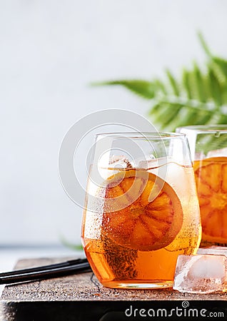 Aperol spritz cocktail in glass with sparkling wine, liqueur, ice and sicilian orange - summer alcohol drink, gray bar counter Stock Photo