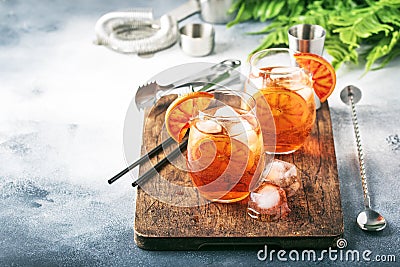 Aperol spritz cocktail in wine glass with sparkling wine, liqueur, ice cubes and red orange - summer Italian low alcohol cold Stock Photo