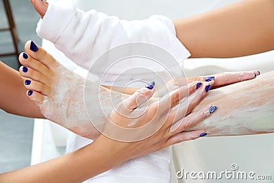 Aplying nourishing moisturizer mask woman legs Stock Photo