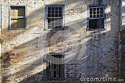 Apparent brick wall of old house with window Stock Photo