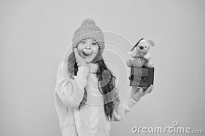 Appease with gift. Shopping tips. Rat symbol of year. Happy girl hold mouse toy and wrapped gift box. Kid knitted Stock Photo