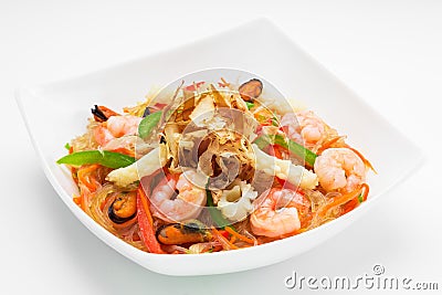 Appetising cellophane noodles with seafood in a white plate, close up on a white background Stock Photo