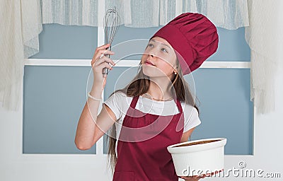 An appetite of pride. kid chef cooking with beater. child prepare healthy food at home and wearing cook uniform Stock Photo