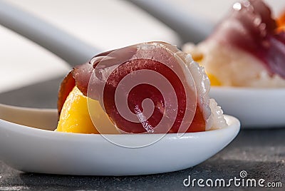 Appetizer ham and egg in porcelain spoon Stock Photo