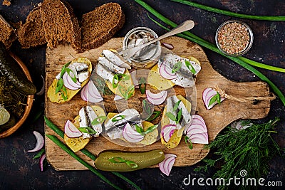 Appetizer of herring anchovy and baked potato Stock Photo