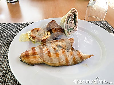 Appetizer Plate with Fish, Sesame Chicken, Turkey Meat and Tuna Fish Wrap. Stock Photo