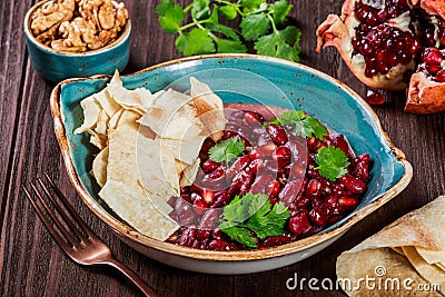 Appetizer with red bean, walnut, butter, coriander, parsley, chips on plate on wooden background. Healthy food. Stock Photo