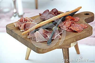 Appetizers boards with assorted meat and salami. Charcuterie platter. Wooden board on a blurry background Stock Photo