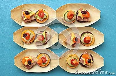 Appetizers in small bowls on a turqoise colored table Stock Photo