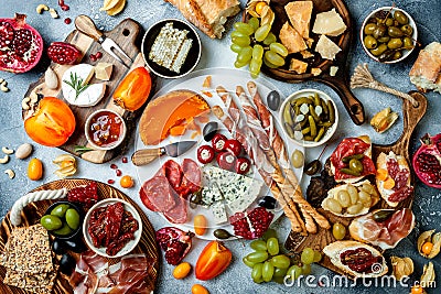 Appetizers table with antipasti snacks. Bruschetta or authentic traditional spanish tapas set, cheese and meat platter Stock Photo