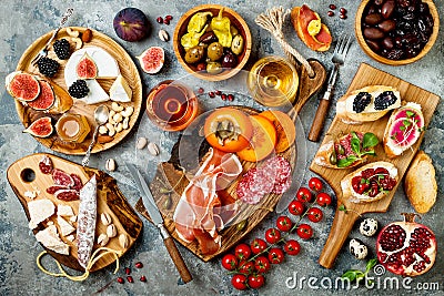 Appetizers table with italian antipasti snacks and wine in glasses. Brushetta or authentic traditional spanish tapas set Stock Photo