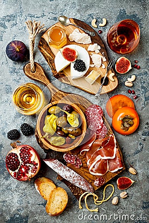 Appetizers table with italian antipasti snacks and wine in glasses. Brushetta or authentic traditional spanish tapas set Stock Photo