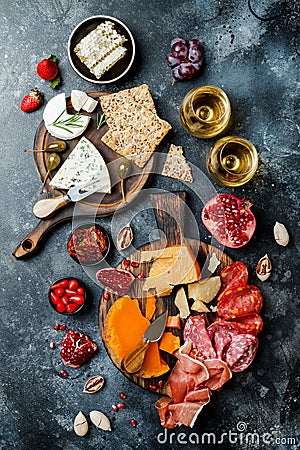 Appetizers table with italian antipasti snacks and wine in glasses. Brushetta or authentic traditional spanish tapas set Stock Photo