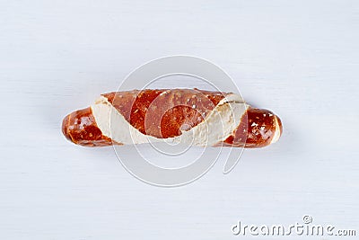 Appetizing Bavarian pretzel roll isolated on a white background. Top view, copy space, Stock Photo