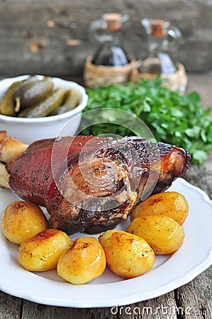 Appetizing Bavarian roast pork knuckle on cutting board Stock Photo