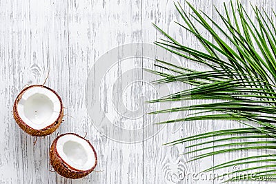 Appetizing coconut and palm branch on white background top view Stock Photo