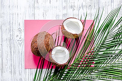 Appetizing coconut and palm branch on white background top view Stock Photo