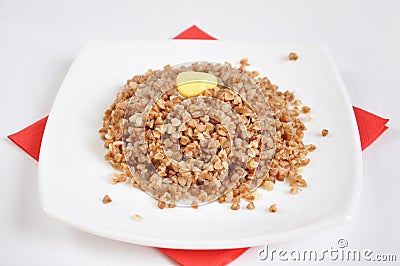 Appetizing crumbly buckwheat with butter Stock Photo