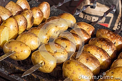 Appetizing potatoes are baked on hot coals Stock Photo