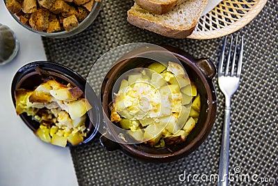 Appetizing roast with potatoes, served in clay pot Stock Photo