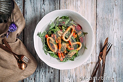 Appetizing seafood salad with vegetables and squid rings Stock Photo