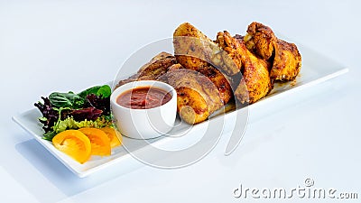 Appetizing spicy baked chicken wings with sweet chili sauce on t Stock Photo