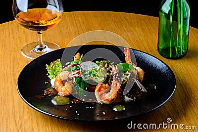 Appetizing spicy salad with shrimps, radish and sauce on the tab Stock Photo