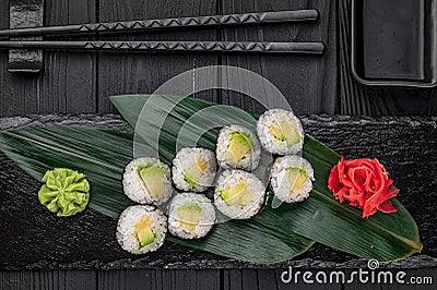 Appetizing sushi maki roll on a black stone plate Stock Photo