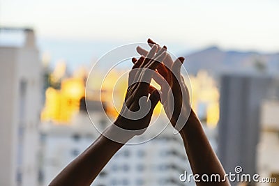 Applause. Woman clapping hands, applauding from balcony to support doctors, nurses, hospital workers, medical staff Stock Photo