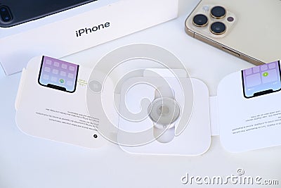 Apple Airtag, white box with electronic tracker, tracker broadcasts secure signal via Bluetooth, received by nearby devices, Editorial Stock Photo