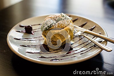 Apple,baked in the oven with honey, nuts and dried fruit.Apple on plate at restaurant.Baked apple with couscous,nuts and Stock Photo