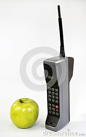 Apple and Brick Cell Phone. Stock Photo